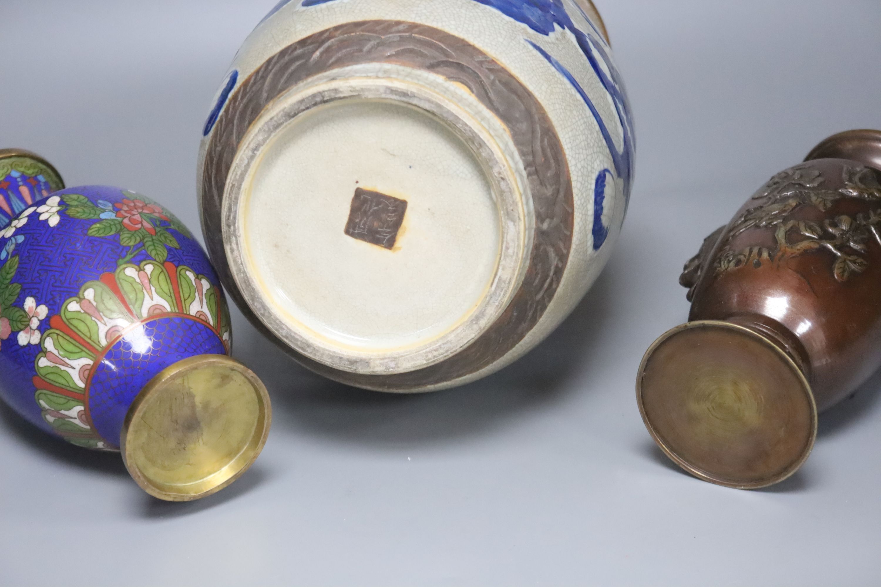 A Chinese blue and white crackle glaze vase, a similar cloisonne vase and a bronze vase, tallest 38cm